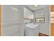 Bright laundry room features a washer, dryer, and built-in storage cabinets at 4120 Chelsea Ln, Lakeland, FL 33809