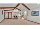 Open-concept living room showcasing vaulted ceilings, wooden beams, and seamless transition to a breakfast nook at 4120 Chelsea Ln, Lakeland, FL 33809