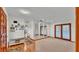Bright living room featuring carpet floors, a bench, and large mirrored wall at 4120 Chelsea Ln, Lakeland, FL 33809