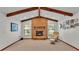 The brick fireplace is the centerpiece of this living room, which features vaulted ceilings and wooden beams at 4120 Chelsea Ln, Lakeland, FL 33809