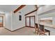 Open-concept living room showcasing vaulted ceilings, wooden beams, and seamless transition to a breakfast bar at 4120 Chelsea Ln, Lakeland, FL 33809