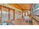 Enclosed patio boasts brick accents, a ceiling fan, and a cozy dining set at 4120 Chelsea Ln, Lakeland, FL 33809
