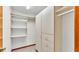 Walk-in closet featuring ample shelving and cabinet space for storage at 4120 Chelsea Ln, Lakeland, FL 33809