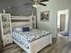 Cozy bedroom with wood-look flooring, stylish furniture and neutral-colored decor at 15917 Mercott Ct, Clermont, FL 34714