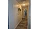 Hallway view featuring laminate flooring and decorative wall art at 15917 Mercott Ct, Clermont, FL 34714