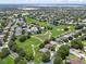 Expansive aerial view of homes in a lush community with ponds and green spaces at 4013 Greystone Dr, Clermont, FL 34711