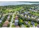 Beautiful aerial view of a residential neighborhood with a golf course and a lake in the background at 4013 Greystone Dr, Clermont, FL 34711