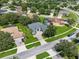 Beautiful aerial view of a home with a well-manicured lawn, mature trees and a paved drive at 4013 Greystone Dr, Clermont, FL 34711