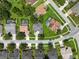 Overhead shot showcasing a community with green lawns, mature trees, and well maintained streets at 4013 Greystone Dr, Clermont, FL 34711