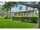 Inviting backyard featuring a neatly trimmed hedge and expansive green lawn, offering privacy at 4013 Greystone Dr, Clermont, FL 34711