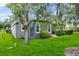 Well-maintained backyard featuring lush green grass, a charming patio, and mature trees at 4013 Greystone Dr, Clermont, FL 34711