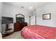 Bedroom featuring a plush bed, dresser with television, and neutral paint at 4013 Greystone Dr, Clermont, FL 34711
