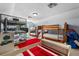 Large bedroom with multiple bunk beds, ideal for a big Gathering, and a TV for entertainment at 4013 Greystone Dr, Clermont, FL 34711