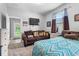 Bright bedroom featuring a sofa, television, and patterned bedding, inviting relaxation and comfort at 4013 Greystone Dr, Clermont, FL 34711