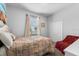 Bedroom features a plush bed, neutral paint, and a view of the yard at 4013 Greystone Dr, Clermont, FL 34711