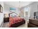 Charming bedroom features a decorative chandelier, plush bed, and soft colors at 4013 Greystone Dr, Clermont, FL 34711