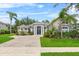 Charming single-story home with a brick driveway, manicured lawn, and lush landscaping at 4013 Greystone Dr, Clermont, FL 34711