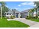 Beautiful home with a well-manicured lawn, brick driveway, and an attached two-car garage at 4013 Greystone Dr, Clermont, FL 34711