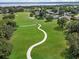 Picturesque golf course view with winding paths, verdant green grass, and beautiful trees at 4013 Greystone Dr, Clermont, FL 34711