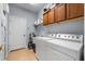 Efficient laundry room equipped with washer, dryer, sink and upper cabinets at 4013 Greystone Dr, Clermont, FL 34711