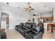 Home theater living room featuring large leather seating and access to the kitchen and dining area at 4013 Greystone Dr, Clermont, FL 34711