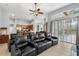 Home theater living room featuring large leather seating and access to the kitchen at 4013 Greystone Dr, Clermont, FL 34711