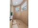 Tiled walk-in shower featuring a rainfall shower head and built-in bench at 4013 Greystone Dr, Clermont, FL 34711