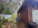 Backyard with white fence, trees and an AC unit with trash cans at 507 Cloudcroft Dr, Deltona, FL 32738