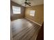 Comfortable bedroom with laminate wood flooring, and natural light streaming in through the windows at 507 Cloudcroft Dr, Deltona, FL 32738