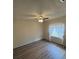 This cozy bedroom features wood-look flooring and a ceiling fan, offering comfort and style at 507 Cloudcroft Dr, Deltona, FL 32738