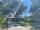 Charming single-story home featuring mature trees and a well-maintained front lawn with a long driveway at 507 Cloudcroft Dr, Deltona, FL 32738