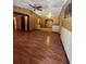 Spacious living room with hardwood floors, ceiling fan, and neutral paint, ideal for entertaining and comfort at 507 Cloudcroft Dr, Deltona, FL 32738