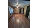 Spacious living room with wood-look floors and ceiling fan, perfect for relaxation and gatherings at 507 Cloudcroft Dr, Deltona, FL 32738