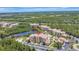 Stunning aerial view of condos with a luxurious community pool surrounded by lush greenery and a peaceful lake at 8601 Worldquest Blvd # 3404, Orlando, FL 32821