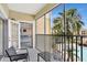 Cozy screened balcony with seating, providing a relaxing outdoor space overlooking the community pool at 8601 Worldquest Blvd # 3404, Orlando, FL 32821