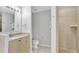 Well-lit bathroom with granite vanity, toilet, and tiled walk-in shower at 8601 Worldquest Blvd # 3404, Orlando, FL 32821