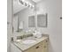 Bathroom with a granite vanity, neutral walls, framed mirrors, and plenty of storage space at 8601 Worldquest Blvd # 3404, Orlando, FL 32821
