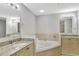 Bright bathroom features double vanity with granite countertops and a luxurious soaking tub at 8601 Worldquest Blvd # 3404, Orlando, FL 32821