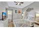 Bedroom featuring a queen bed, neutral decor, TV, and a decorative wall art piece at 8601 Worldquest Blvd # 3404, Orlando, FL 32821