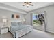 Bright bedroom with a large window, ceiling fan, and serene decor for a relaxing atmosphere at 8601 Worldquest Blvd # 3404, Orlando, FL 32821