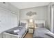 Bright bedroom featuring twin beds, neutral decor, and a sliding door closet for storage at 8601 Worldquest Blvd # 3404, Orlando, FL 32821