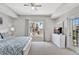 Well-lit bedroom with balcony access, large window, and a comfortable bed for restful nights at 8601 Worldquest Blvd # 3404, Orlando, FL 32821