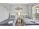 Neutral-toned bedroom with twin beds, matching nightstands, and a decorative wall art piece at 8601 Worldquest Blvd # 3404, Orlando, FL 32821
