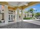 Inviting covered entrance with columns, elegant lighting, and beautiful landscaping at 8601 Worldquest Blvd # 3404, Orlando, FL 32821