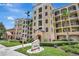 Beautiful exterior view of building with well-manicured landscaping, blue sky, and architectural details at 8601 Worldquest Blvd # 3404, Orlando, FL 32821