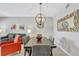 Elegant dining area with stylish chandelier, seating for six, and views into the cozy living space at 8601 Worldquest Blvd # 3404, Orlando, FL 32821