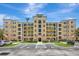 Front exterior view of a condo building featuring manicured lawns, ample parking, and a welcoming facade at 8601 Worldquest Blvd # 3404, Orlando, FL 32821