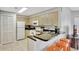 Kitchen with tile floor, bar seating, and white appliances at 8601 Worldquest Blvd # 3404, Orlando, FL 32821