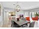 Open-concept living and dining area with a modern kitchen, comfortable seating, and access to outdoor living at 8601 Worldquest Blvd # 3404, Orlando, FL 32821