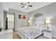Serene bedroom with a ceiling fan, queen bed, neutral colors, and large window views at 8601 Worldquest Blvd # 3404, Orlando, FL 32821